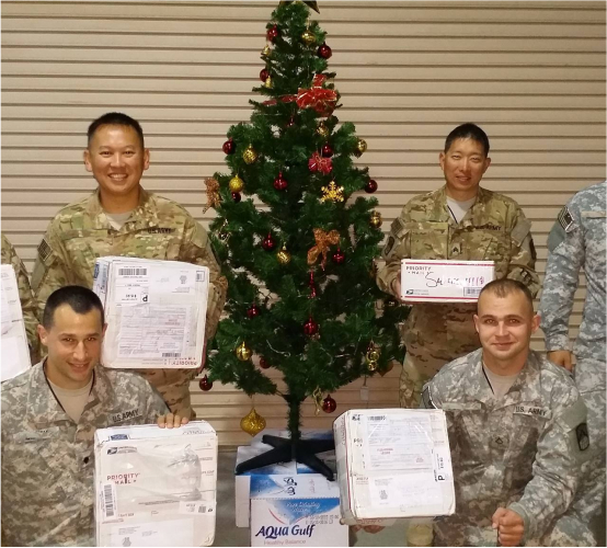 Soldiers holding Christmas care packages